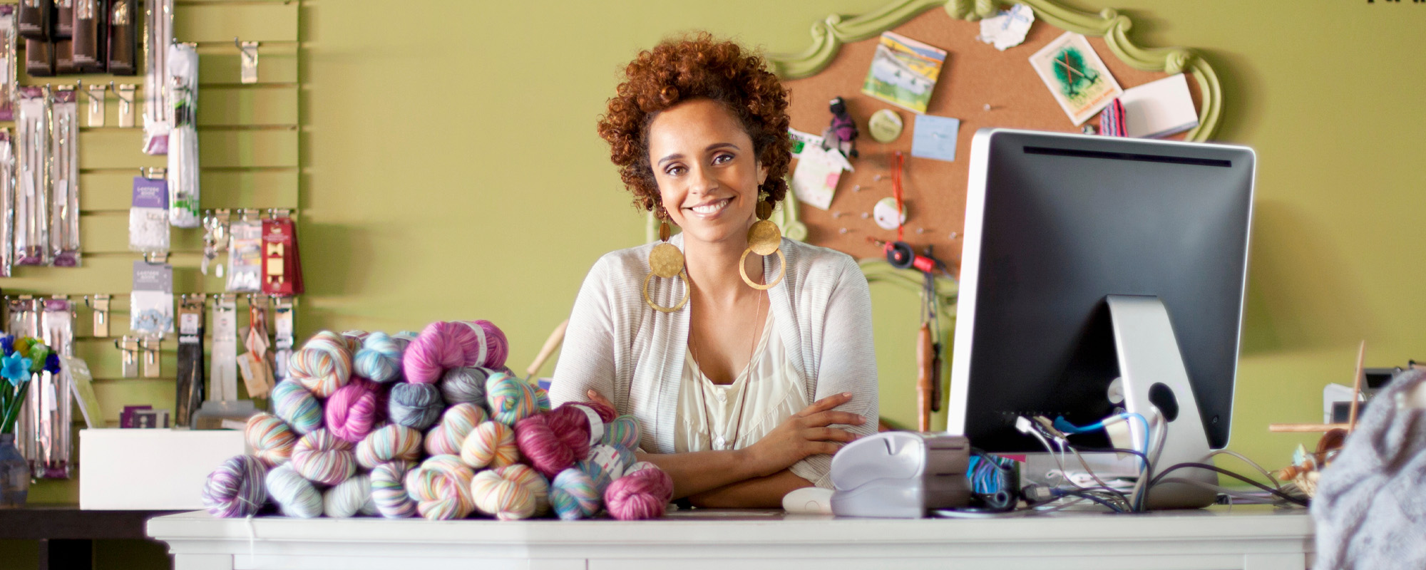 business owner of yarn shop at counter